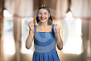 Young excited woman on blurred background.