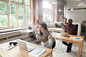 Young excited woman sharing achievement success with colleagues