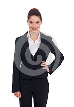 Young exec on the rise. Studio shot of a happy-looking young business woman standing with her hand on her hip isolated