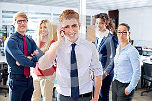 Young executive talking phone in multi ethnic team