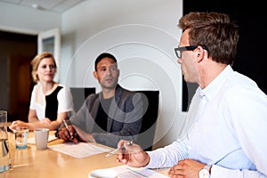 Young executives facing eachother during meeting photo