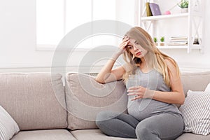 Young expectant blonde with headache copy space