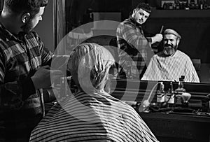 Young expertise. Designing haircut. barber tools in barbershop. handsome hairdresser cutting hair of male client