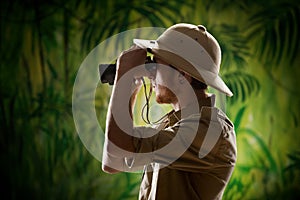 Young explorer looking through binoculars