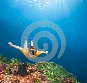 Young explorer snorkeling underwater