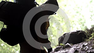 Young explorer standing in a cave with climbing equipment ready for action, travelling and extreme concept. Stock