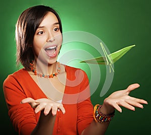 Young expression woman with paper bird