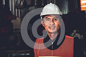 Young factory job worker or engineer close up portrait in manufacturing factory