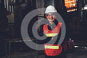 Young factory job worker or engineer close up portrait in manufacturing factory