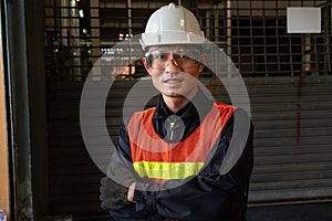 Young factory job worker or engineer close up portrait in manufacturing factory