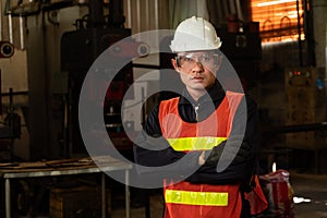 Young factory job worker or engineer close up portrait in manufacturing factory