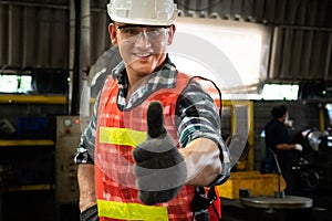 Young factory job worker or engineer close up portrait in manufacturing factory