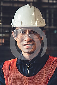 Young factory job worker or engineer close up portrait in manufacturing factory