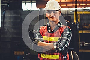 Young factory job worker or engineer close up portrait in manufacturing factory