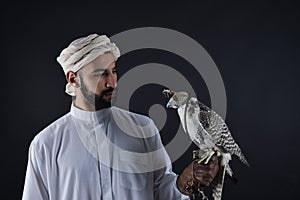 Young falconer holding a bird of prey.