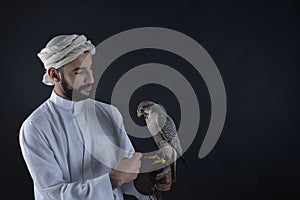 Young falconer holding a bird of prey.