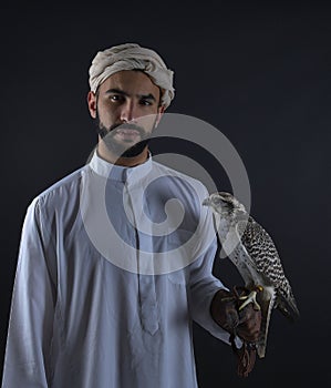 Young falconer holding a bird of prey.