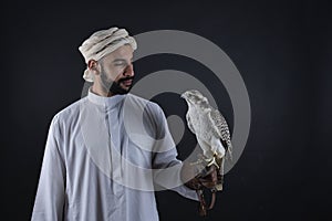 Young falconer holding a bird of prey.