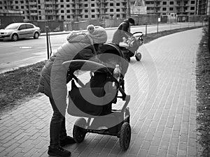 Young families with children in strollers for a walk