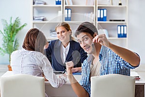 The young family agreeing mortgage contract in the bank for new house