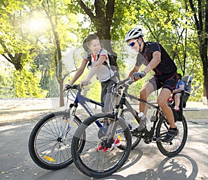 Young family on bicycles riding