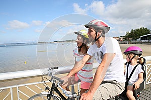 Young family on a biking days by the seaside