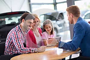 Young family in car dealership
