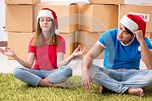 The young family celebrating christmas in new home