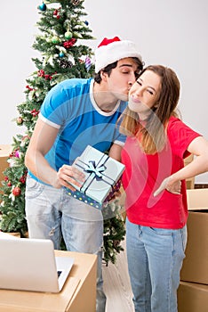 The young family celebrating christmas in new home