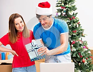 Young family celebrating christmas in new home