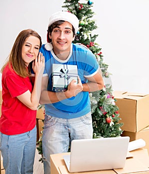 Young family celebrating christmas in new home