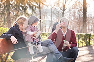 Young family with cheerful child in the park.