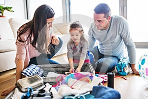 Young family with a child packing for holiday.