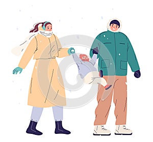 Young family with child walking outdoors in winter