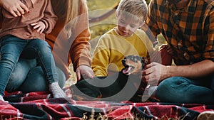 Young family with children and a dog in an autumn park