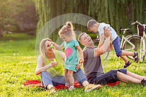Young family with children having fun in nature