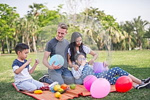 Young family with children having fun in nature.