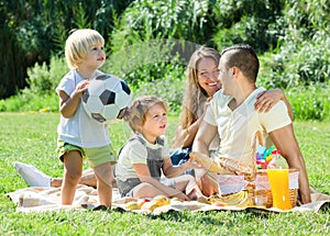 Young family with children having picnic outdoor