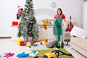 The young family cleaning apartment after christmas party