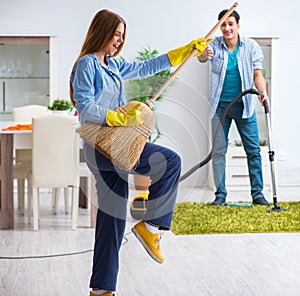 Young family cleaning the house