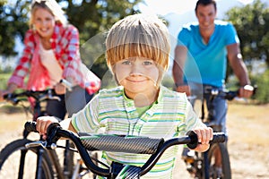 Young family on country bike ride