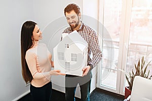 Young family couple purchase rent property real estate . Agent giving consultation to man and woman. Signing contract