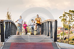 Young family cycling at the city park