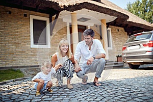 Young family with daughter in crouch