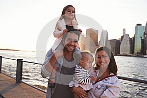 Young family with daughters standing on quayside, close up