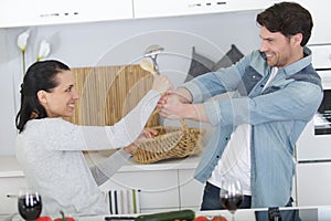 Young family doing funny fight at kitchen