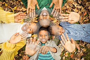 Young family doing a head circles and raising their hands