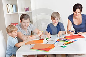 Young family drawing with colorful pencils