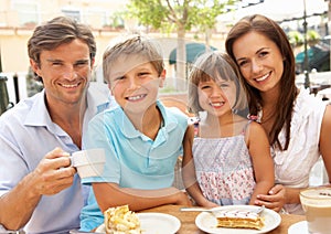 Young Family Enjoying Cup Of Coffee