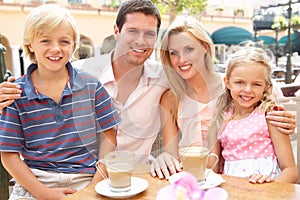 Young Family Enjoying Cup Of Coffee